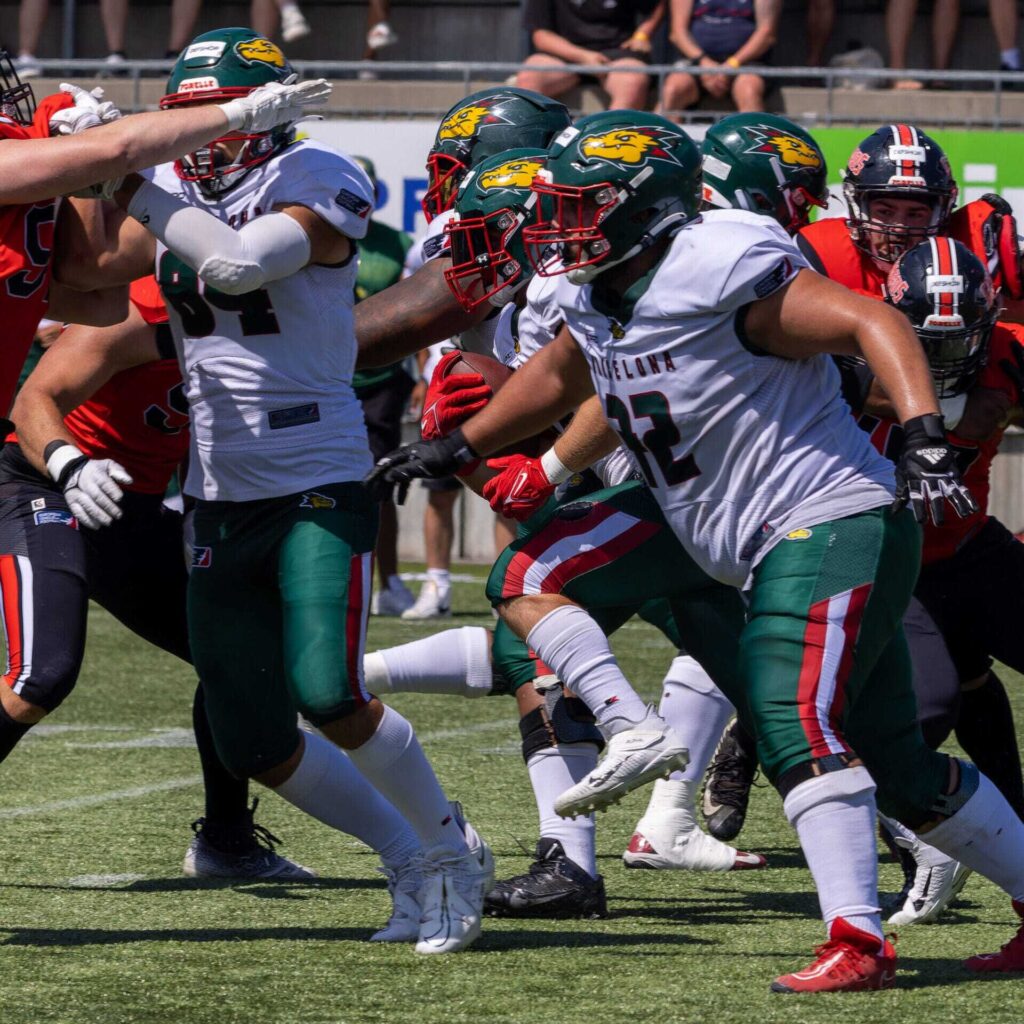 American football players in action, a running play with intense focus.