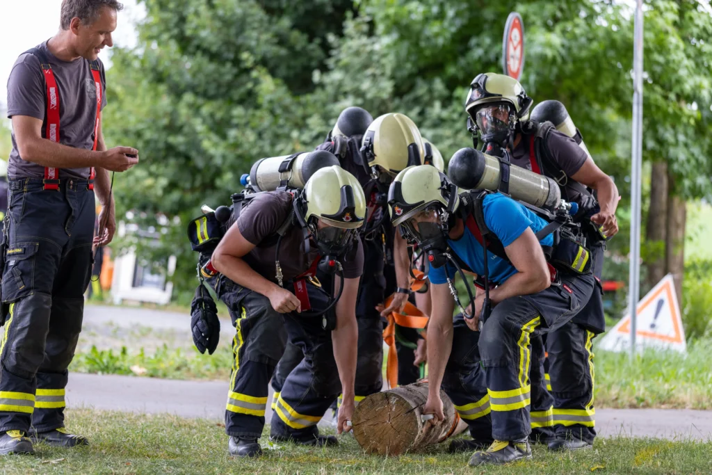 Firefighter team huddled together preparing equipment during a competition