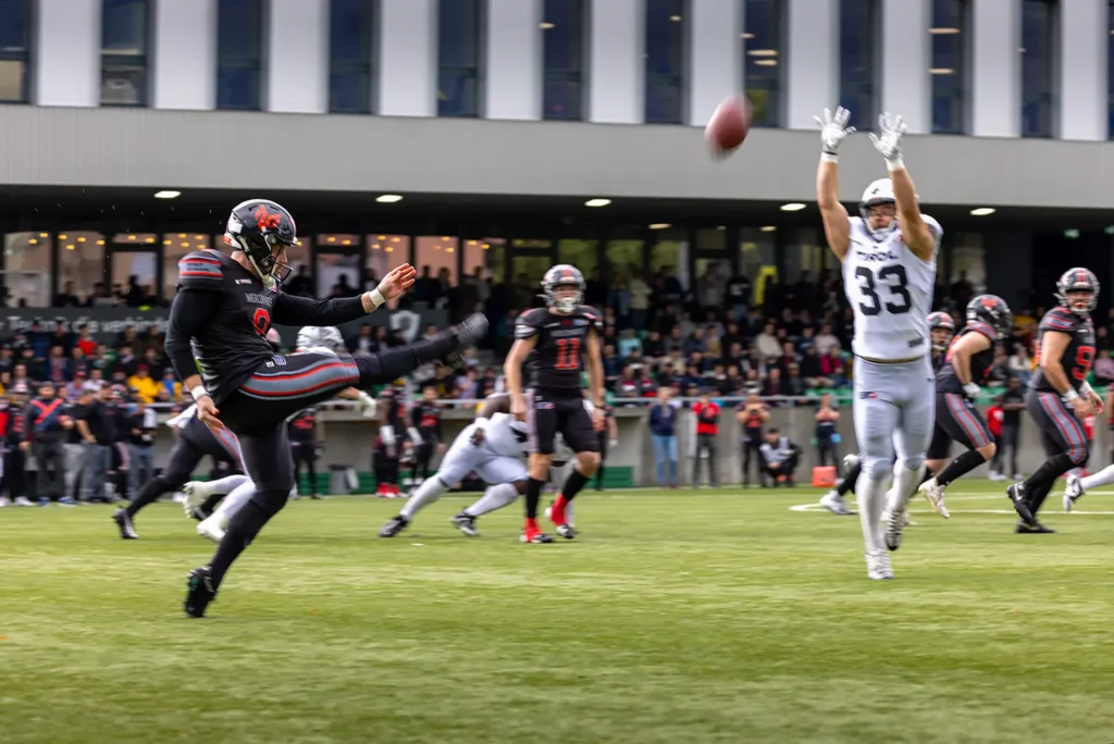 Football kicker in action during an outdoor sports match.