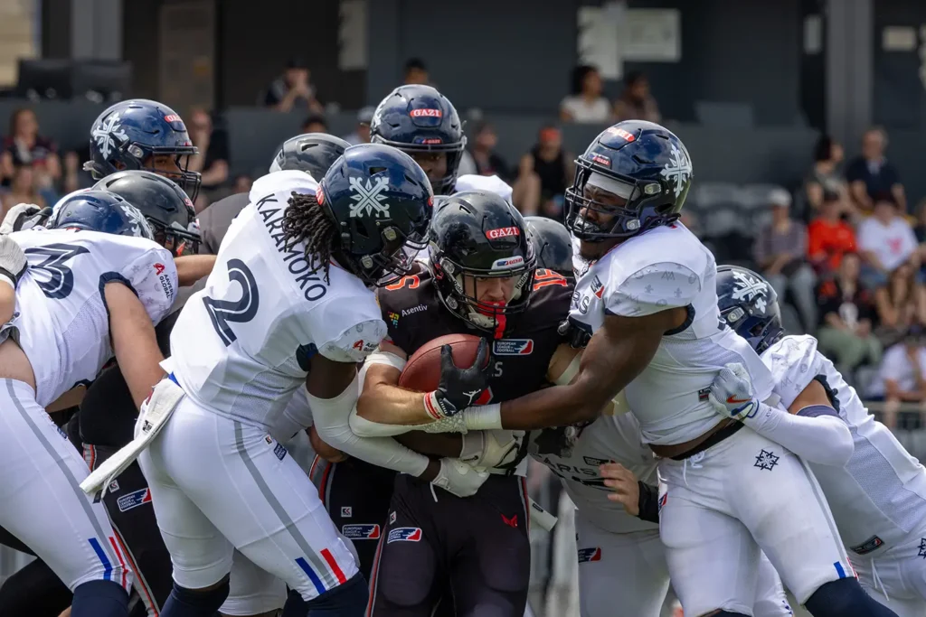American football players in a scrum, battling for possession of the ball.