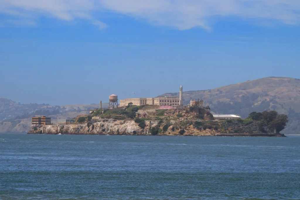 Scenic view of Alcatraz Island under a bright blue sky.