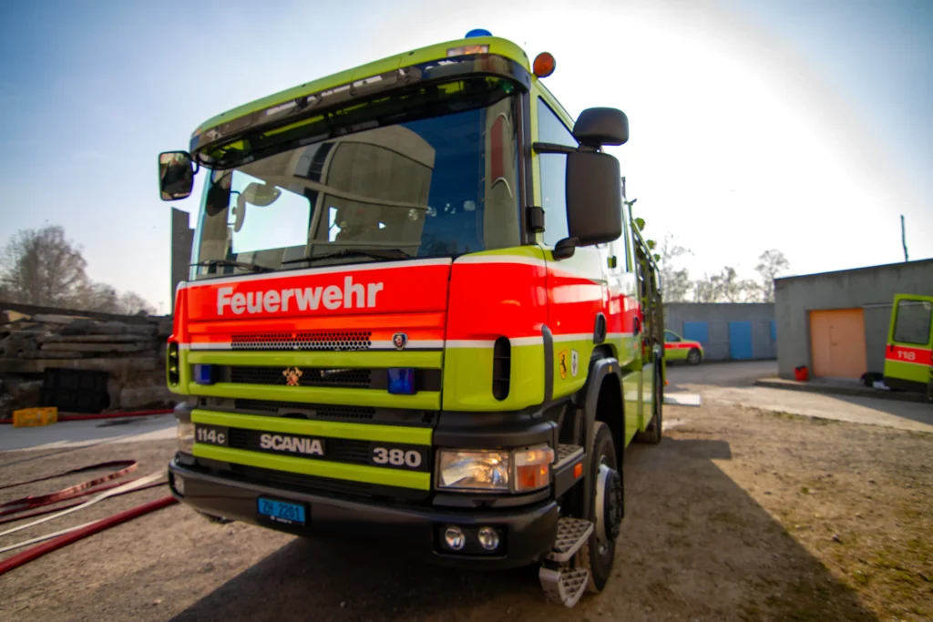 Front view of a Scania Feuerwehr fire engine, green and red.